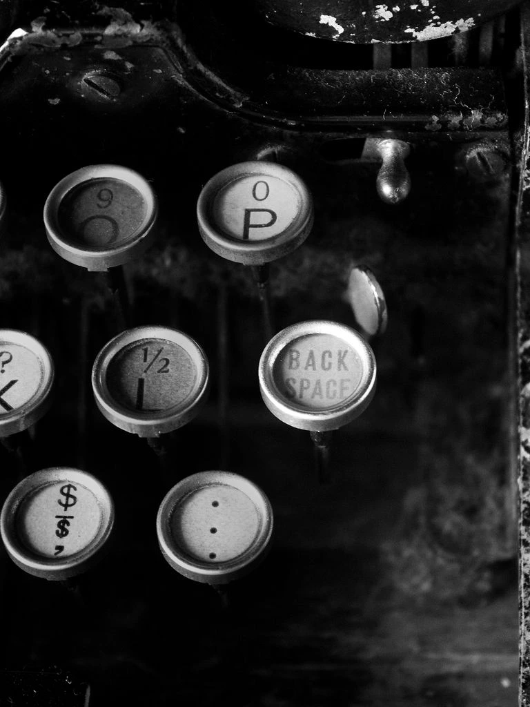 Typewriter with a half-typed page, warm low light